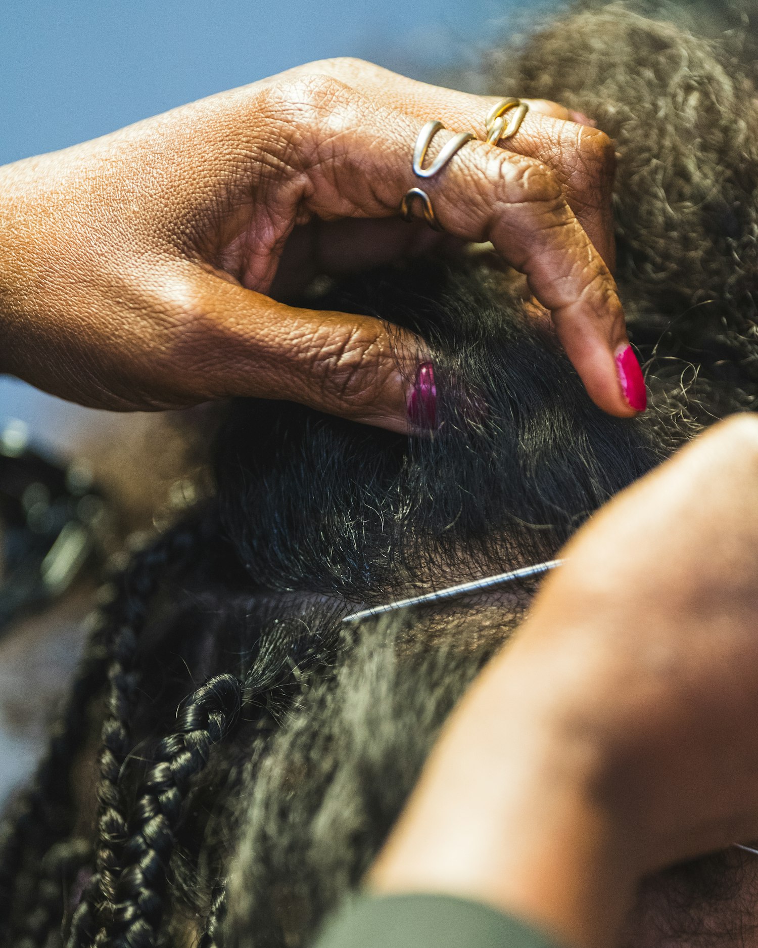 Hands braiding textured hair