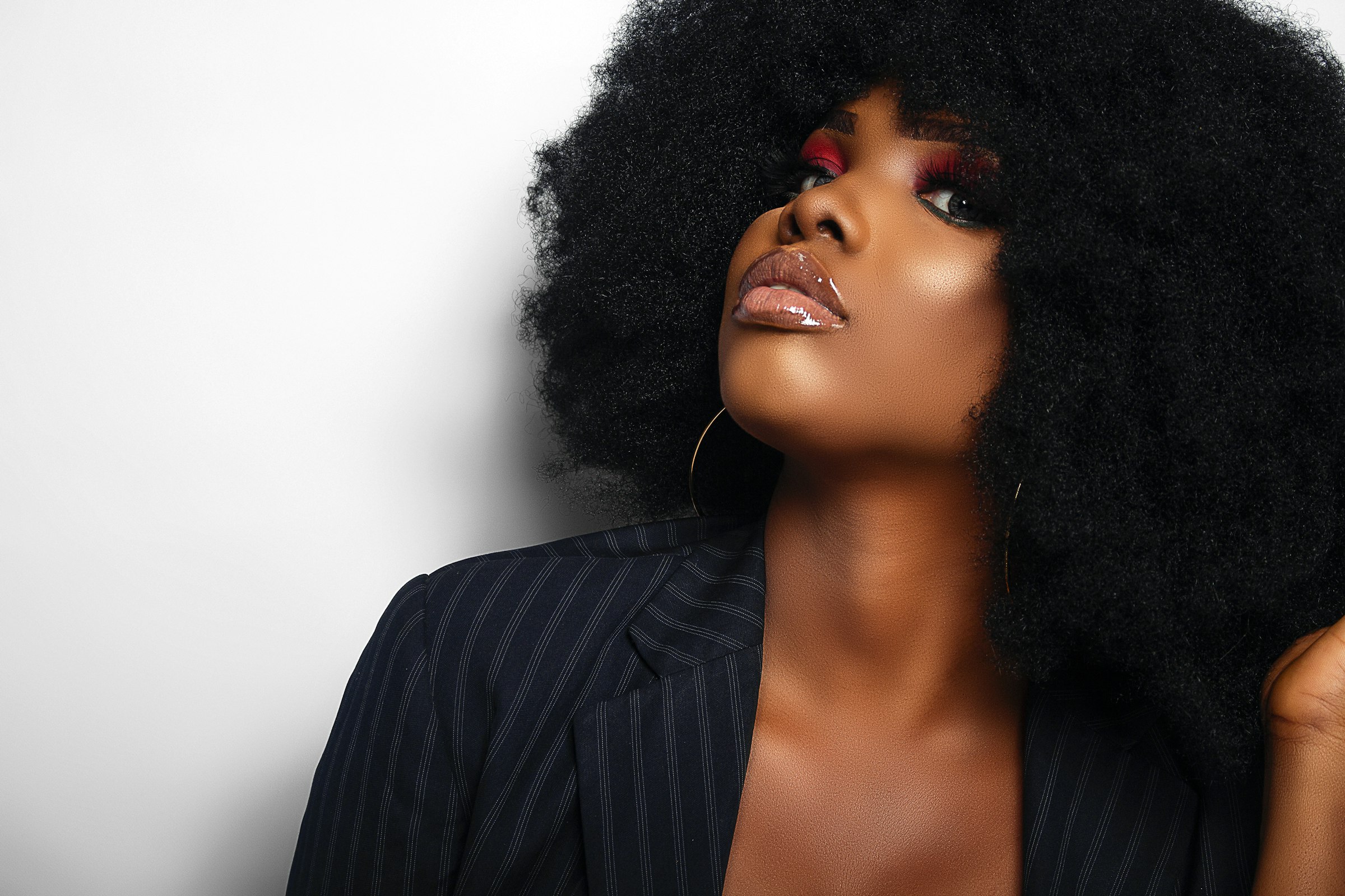 Woman with a full natural afro looking upwards